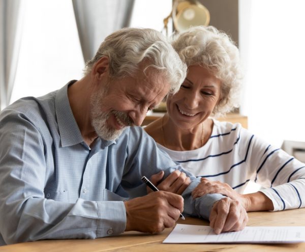 wealthy couple signing mortgage papers