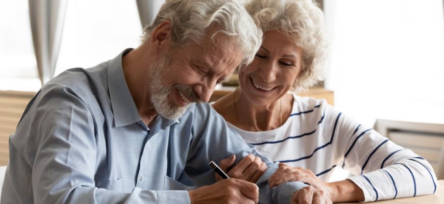 wealthy couple signing mortgage papers