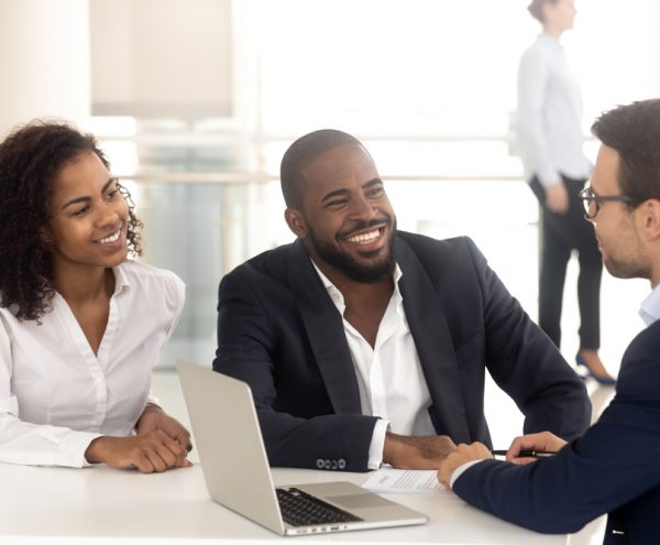 2 happy customers being briefed on the status of their investment portfolio