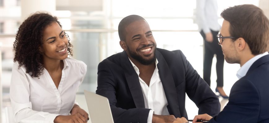 2 happy customers being briefed on the status of their investment portfolio